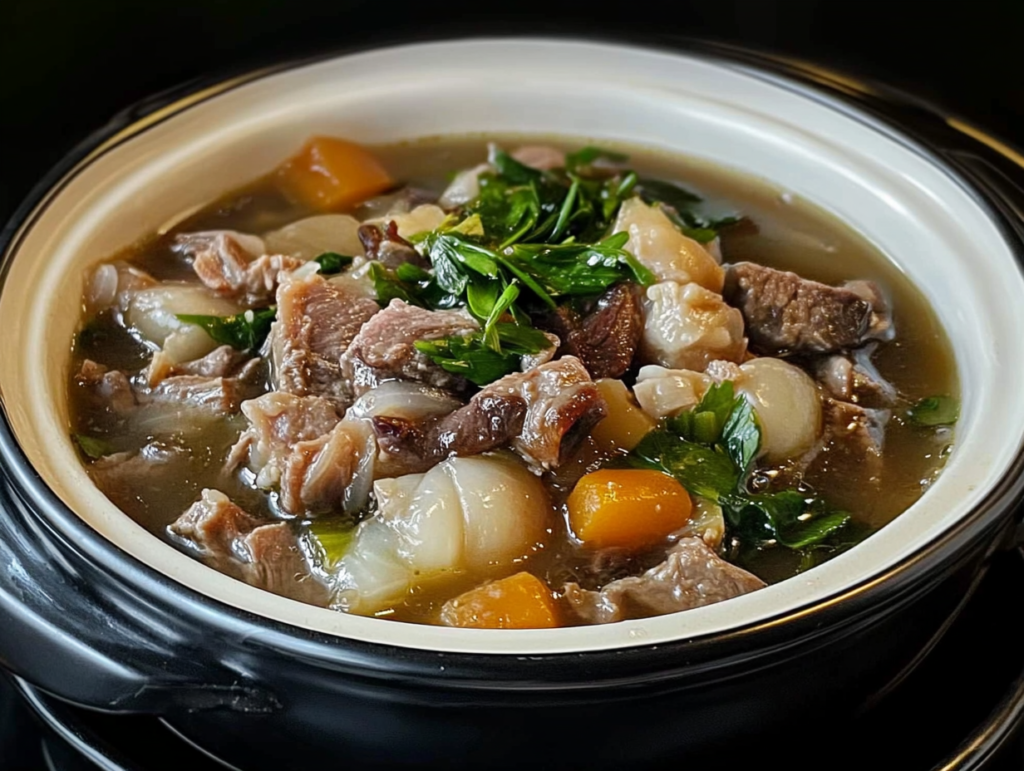 A steaming bowl of beef tendon stew with tender meat, carrots, leafy greens, and a savory broth, served in a black and white ceramic pot.